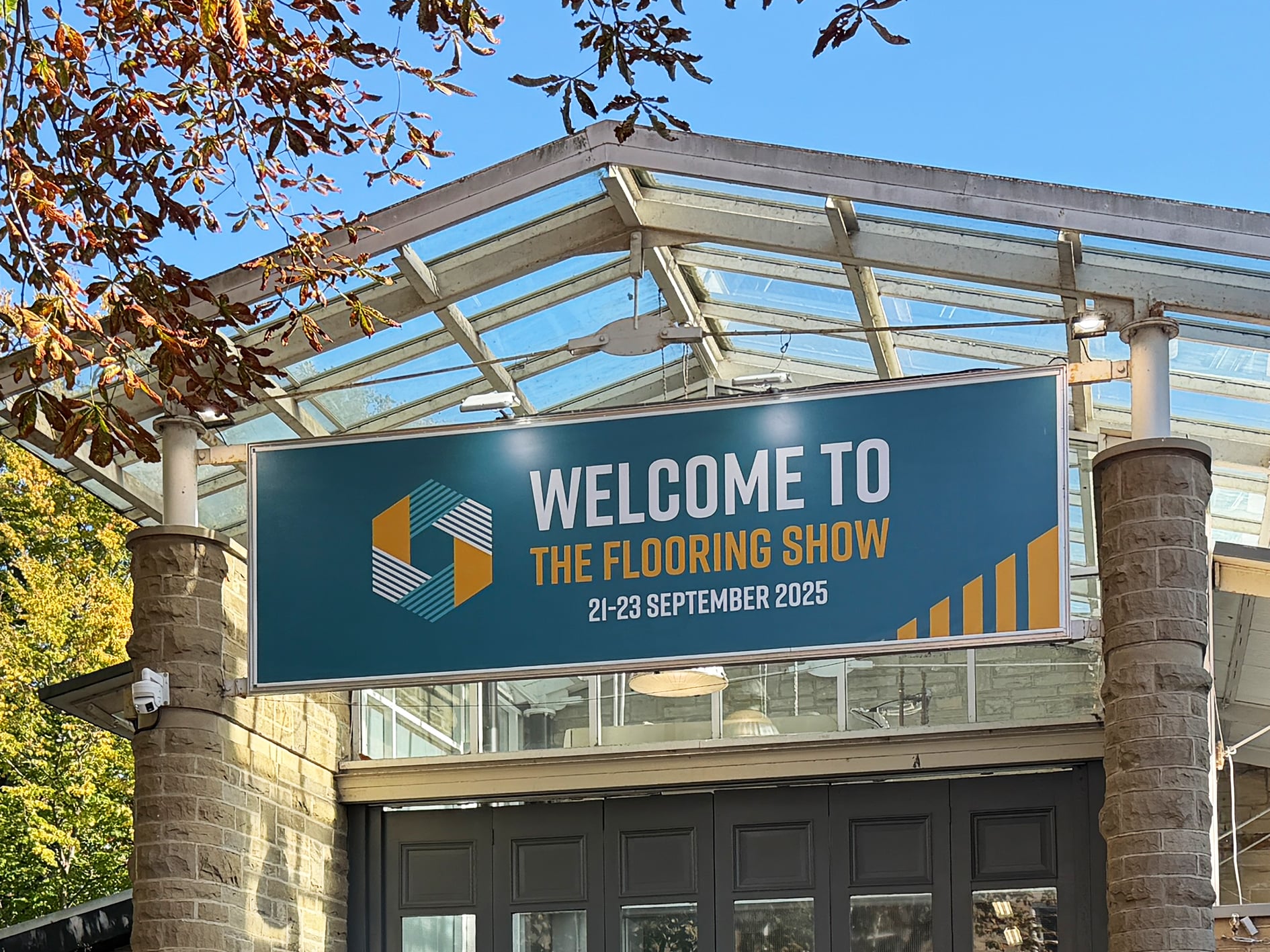 ntrance banner at The Flooring Show 2025, welcoming visitors to explore the latest flooring trends and innovations in carpets, tiles, vinyl, and wood flooring.