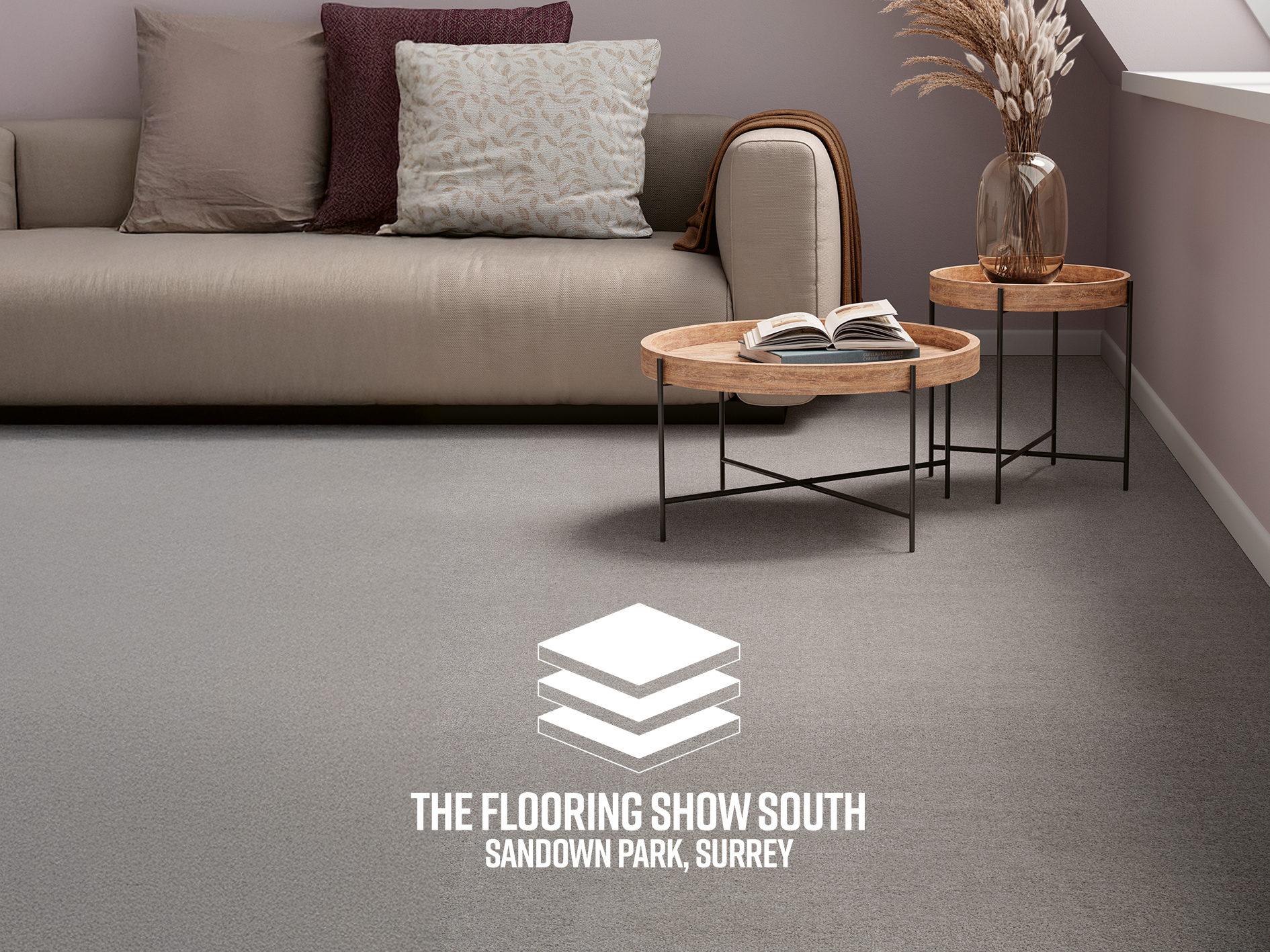 Modern living room with soft grey carpet and neutral décor, promoting The Flooring Show South at Sandown Park.”