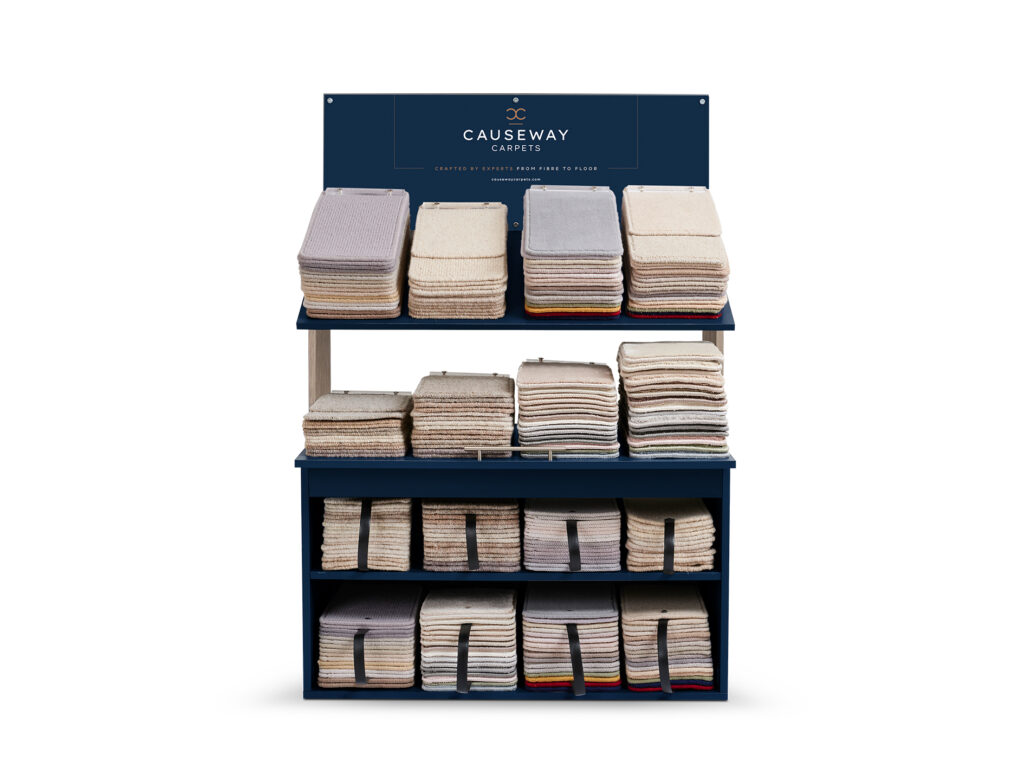 Large carpet sample display unit with stacked fabric swatches and Causeway Carpets branding.
