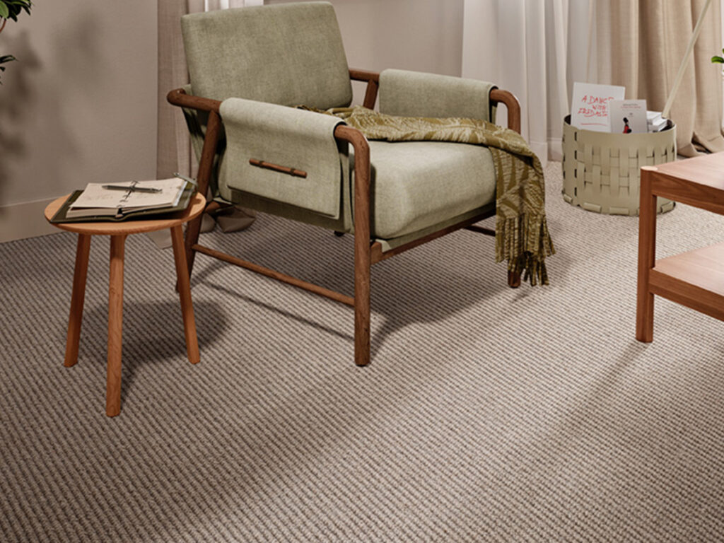 Neutral chunky weave wool carpet in a modern living room, showing textured loop pile wool flooring in warm natural tones.