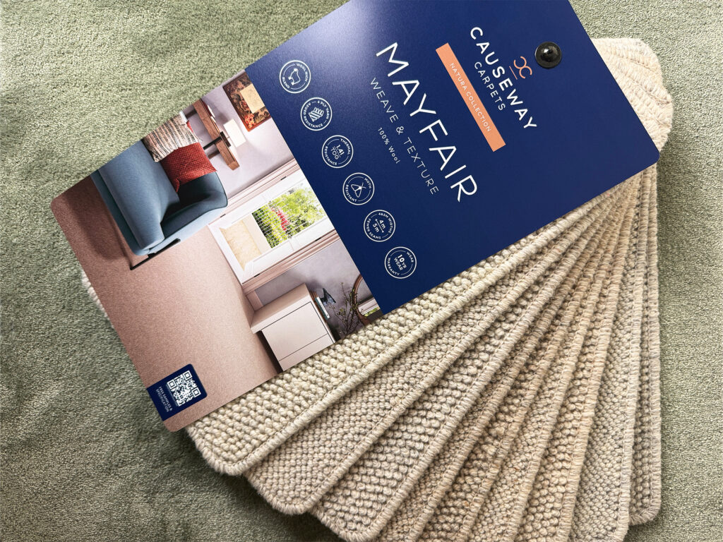 Causeway Carpets Mayfair Weave & Texture wool carpet sample book with loop pile swatches in neutral tones.