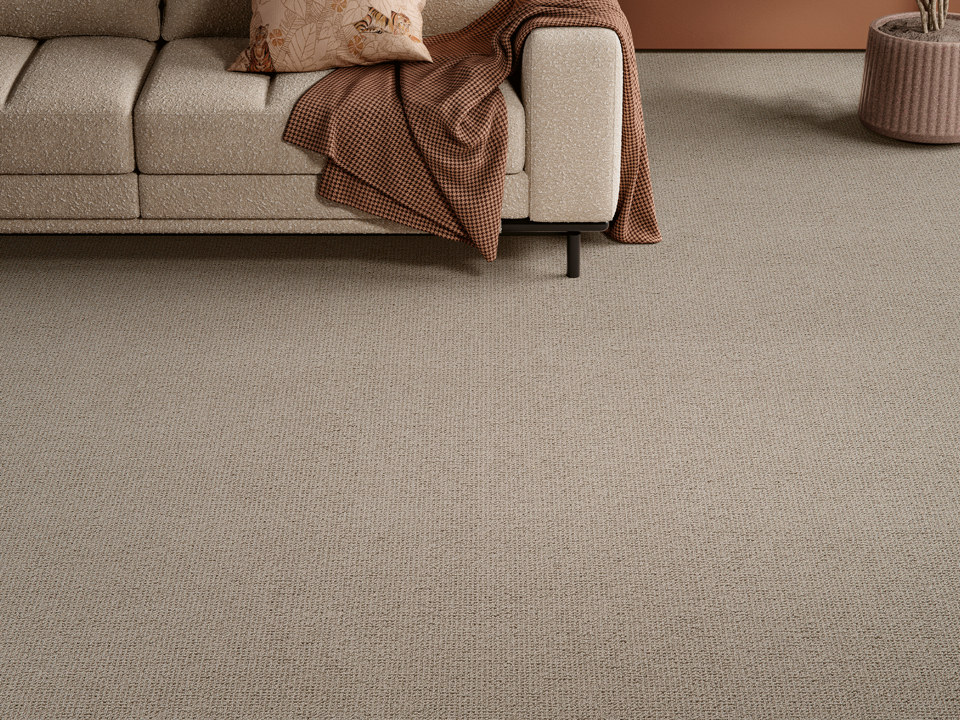 Luxury textured beige carpet in a contemporary living room with designer sofa and warm neutral décor, showcasing premium woven carpeting for elegant homes, luxury apartments and sophisticated interior design spaces.