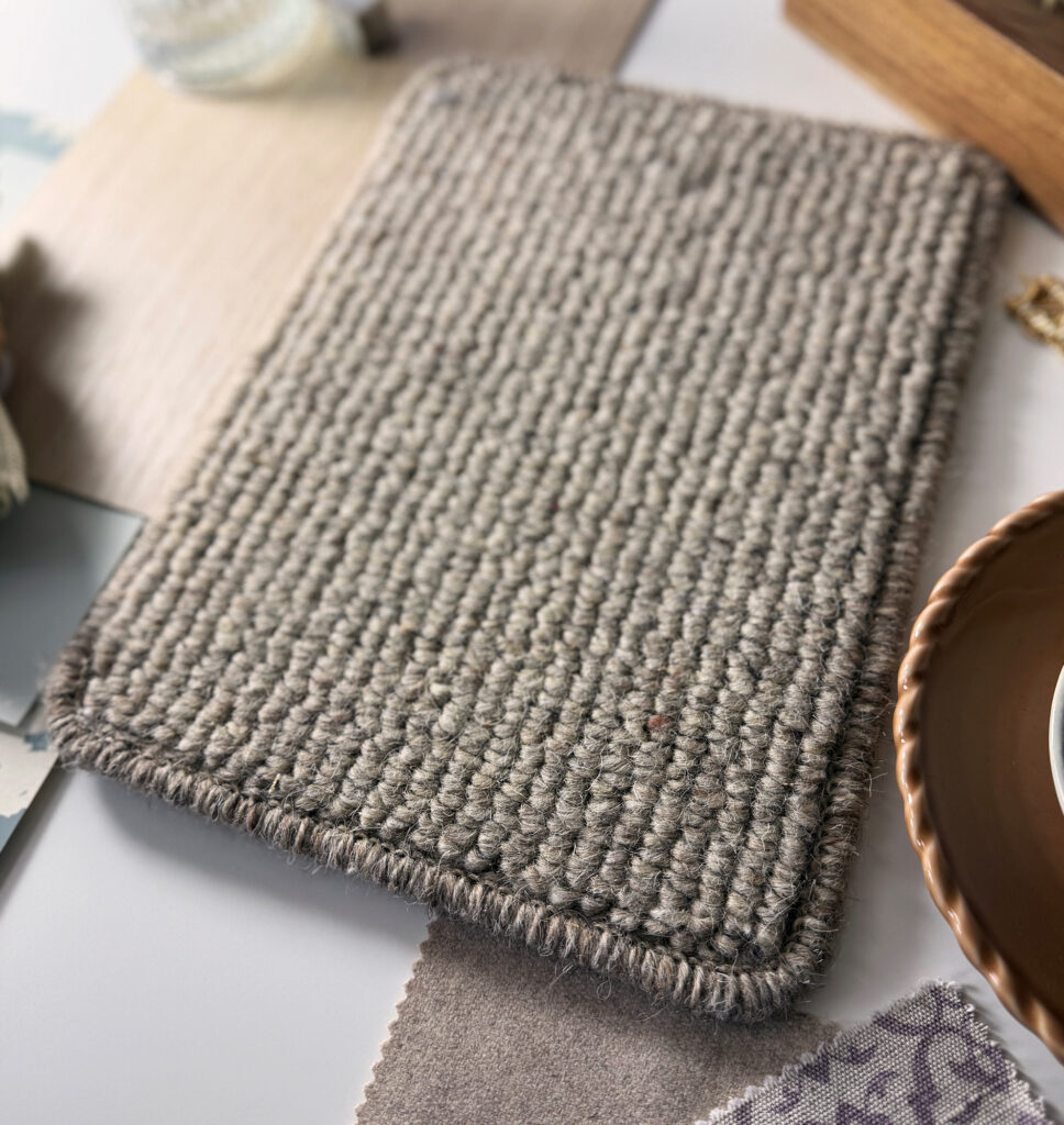Textured loop pile carpet sample in a warm natural taupe shade, highlighting timeless neutral colour trends for stairs and landings.