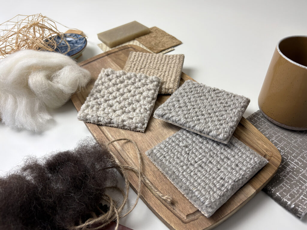 Natural wool fibres and textured wool carpet samples in soft neutral tones, highlighting wool carpet for durable stairs and landings.